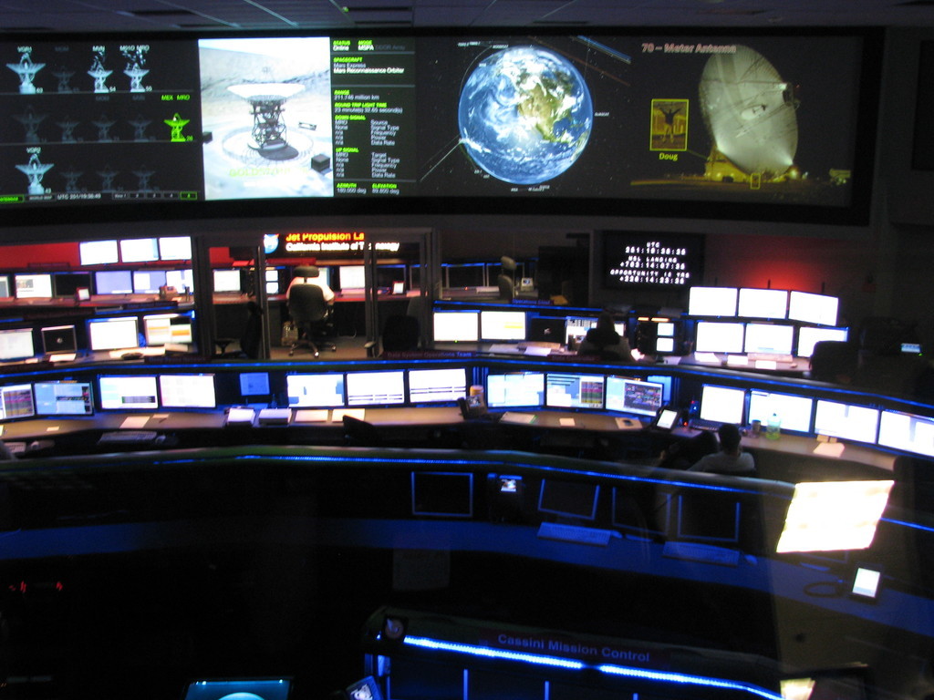 Inside JPL's space flight ops facility (sorry about the blurry picture). The Doug in the picture at the rear right is Doug Ellison. The room from which the ops team monitored the landing of all mars rovers so far (Sojourner, MER, Tango Delta Nominal MSL) is just to the left.