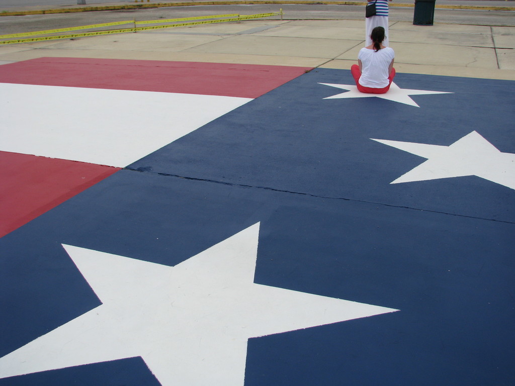 A 1:1 scale section of the US flag from the VAB for scale; each star is nearly the size of a person.