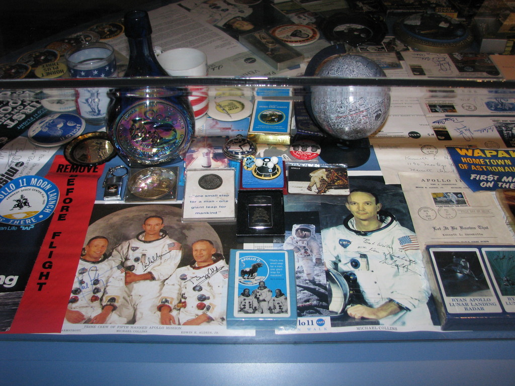 Apollo 11 memorabilia. The big photo to the lower left is noteworthy in that it includes Neil Armstrong's signature. However, Aldrin already signed with the Buzz Aldrin he also used in all of his later autographs, distinct from his Edwin E. Aldrin, Jr. signature on the plaque left on the Moon.