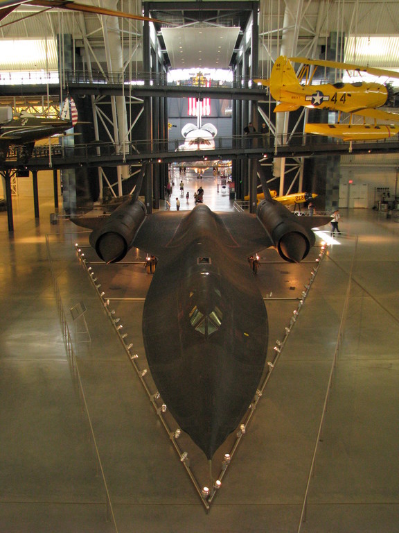 A SR-71 Blackbird, an innovative long-range, high-speed and high-altitude spy plane used for over 30 years in the late 20th century. The Space Shuttle Discovery is in the background.