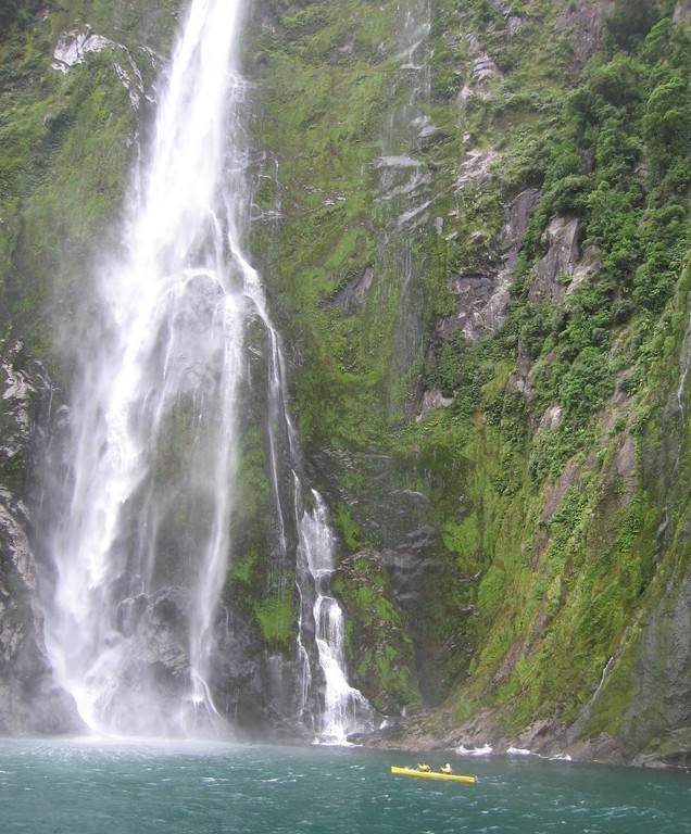 One of Milford Sound's numerous waterfalls, with some brave kayakers closing in.