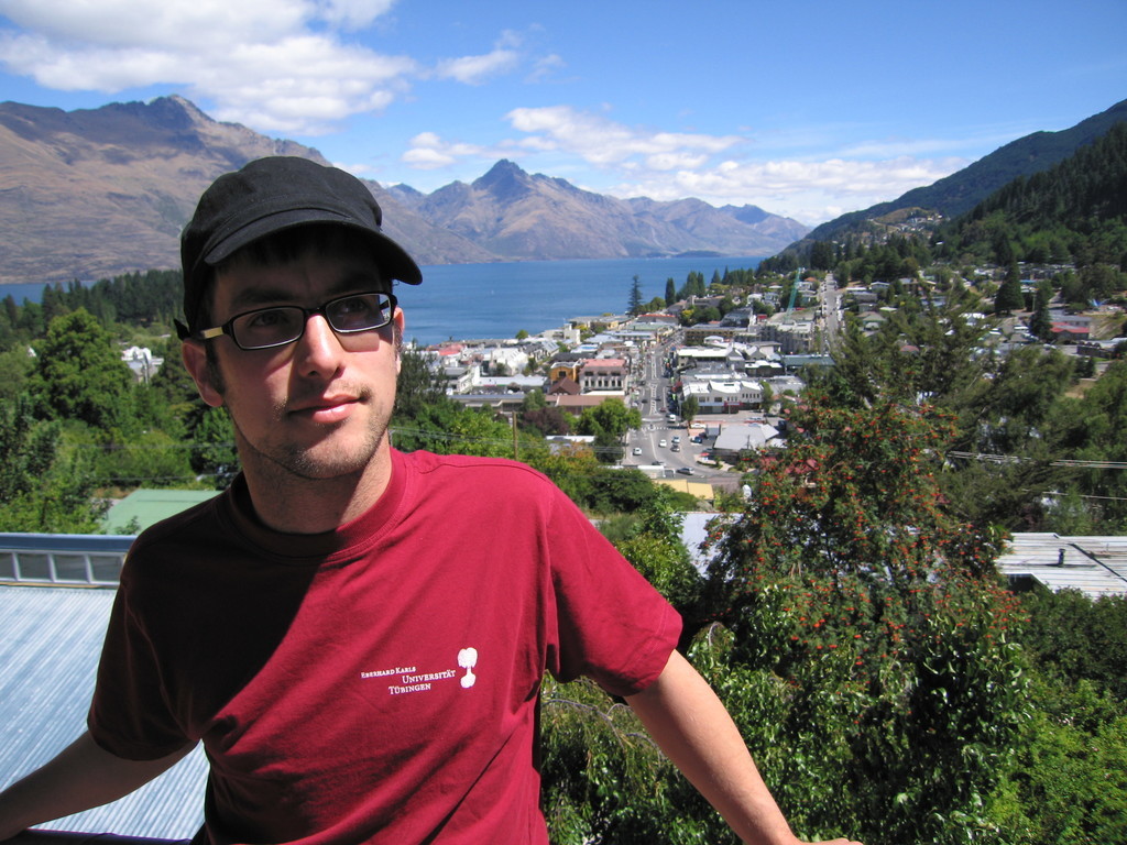 Me in Queenstown, by now having acquired more hair and still wearing my new cap and glasses.