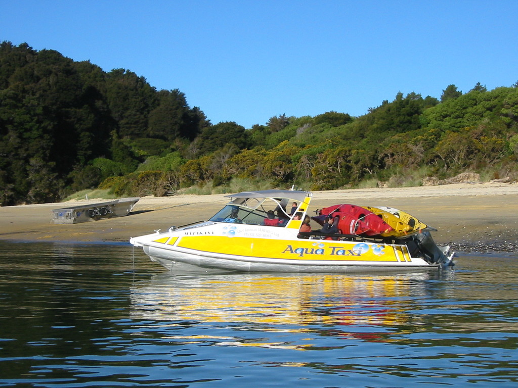 A different company's water taxi, collecting some kayaks and passengers
